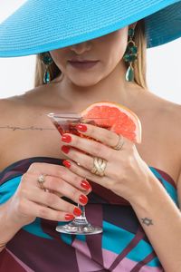 Midsection of a woman drinking glass