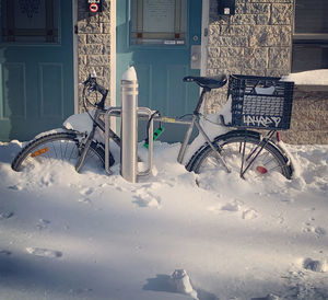 Bicycle on snow covered building