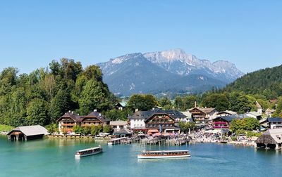 Scenic view of houses and mountains against clear sky