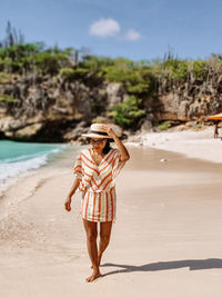 Full length of woman walking on beach