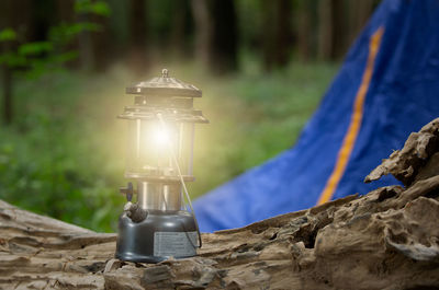 Close-up of illuminated lantern on rock