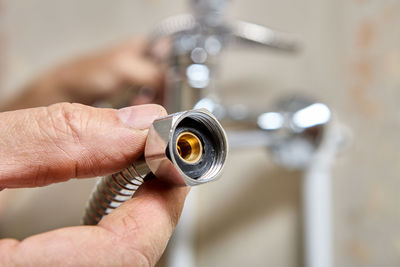 Cropped hand of person holding camera