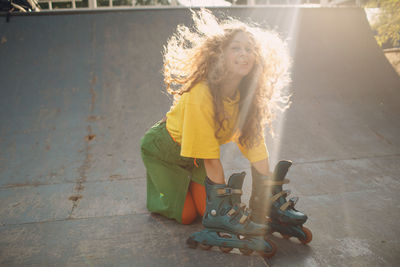 Smiling woman skating on ramp