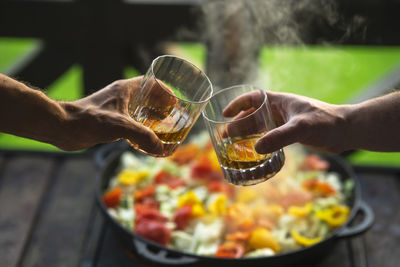 Two men drinking whiskey at the party at home