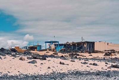 Panoramic view of abandoned fishermans home against sky