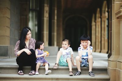 Portrait of a smiling family sitting outdoors