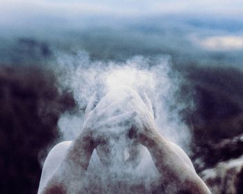 Man putting powder paint on head outdoors