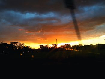 Silhouette of landscape against cloudy sky