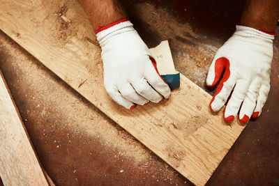 Low section of man sitting on wood