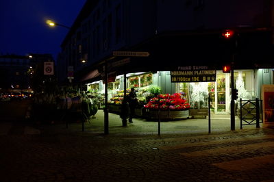 Illuminated street market at night