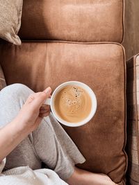 Midsection of woman holding coffee cup