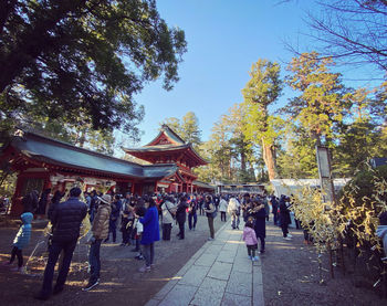 Group of people walking in front of temple