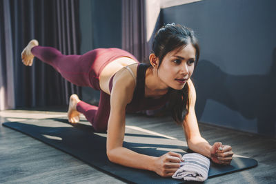 Happy young woman lying on floor