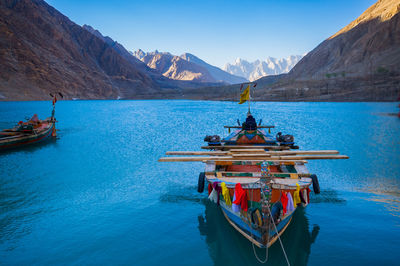 Ship in sea against mountains