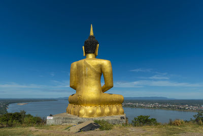 Statue of temple against blue sky