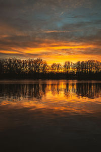 Scenic view of lake against romantic sky at sunset