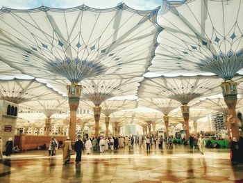 Group of people walking on tiled floor