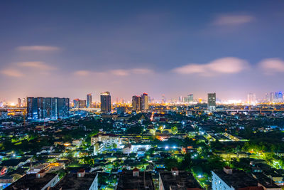 Illuminated cityscape against sky