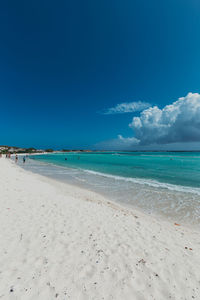 Scenic view of beach against blue sky