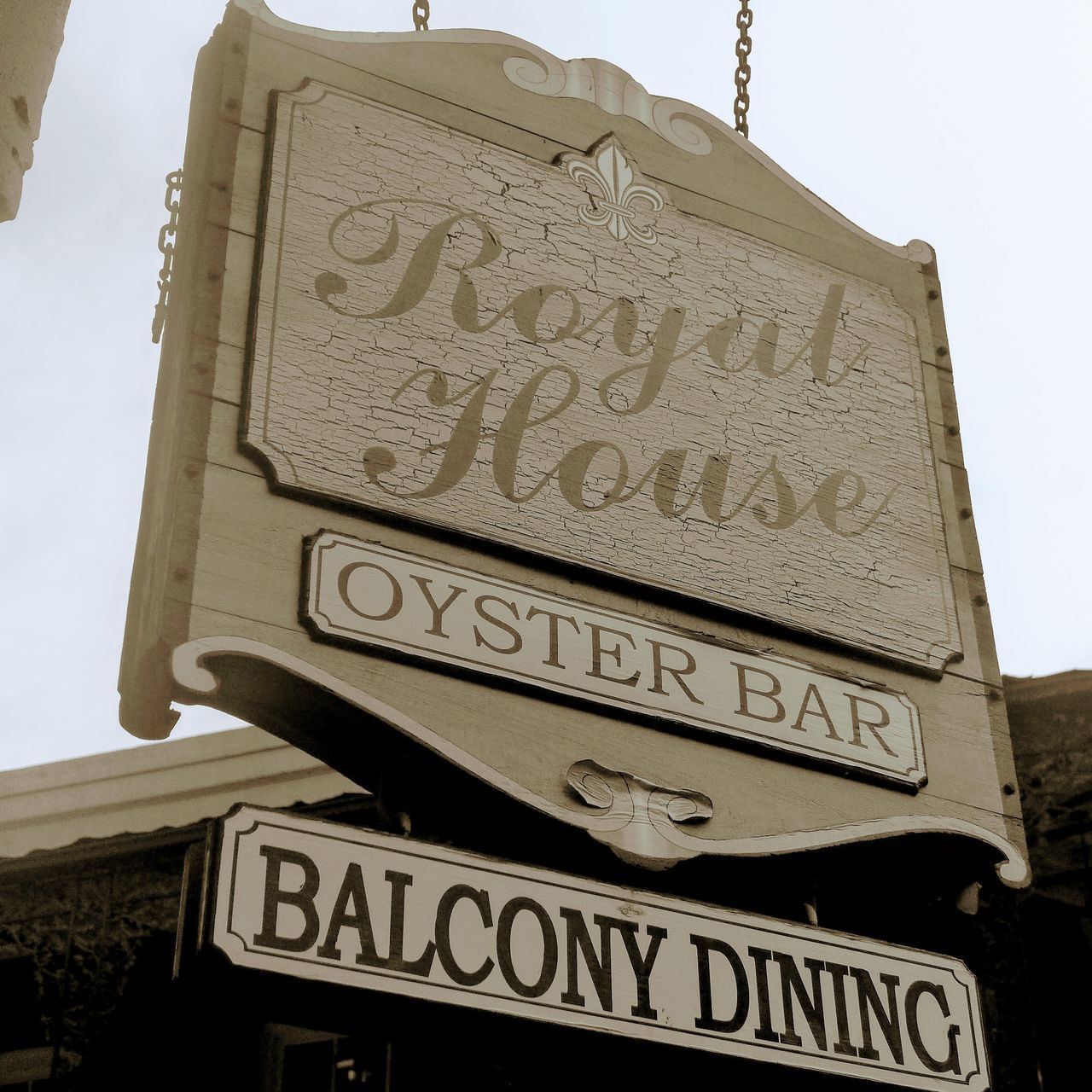 LOW ANGLE VIEW OF TEXT ON BUILDING AGAINST CLEAR SKY