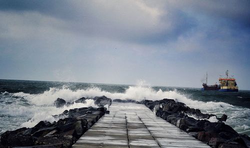 Scenic view of sea against cloudy sky