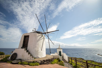 Azores windmill, at corvo island, by the atlantic ocean, good weather.