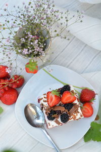 High angle view of dessert with strawberries on table