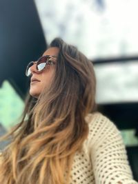 Low angle view of woman wearing sunglasses looking away