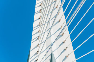 Low angle view of modern building against clear blue sky