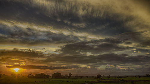 Scenic view of field against sky during sunset