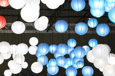 Low angle view of illuminated lanterns hanging on ceiling