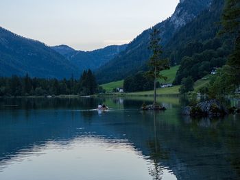 Scenic view of lake and mountains against sky