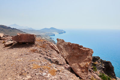 Scenic view of sea and mountains against sky