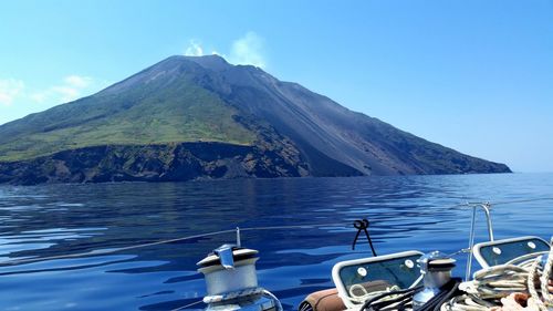 Volcano mountain by island against sky