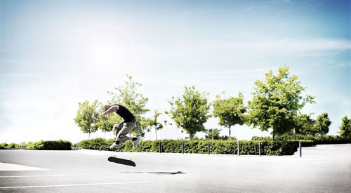 Man skateboarding against sky