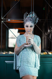 Midsection of woman drinking glass