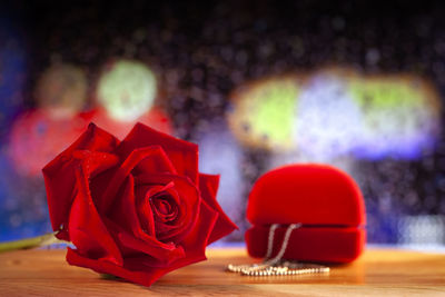 Close-up of red rose on table