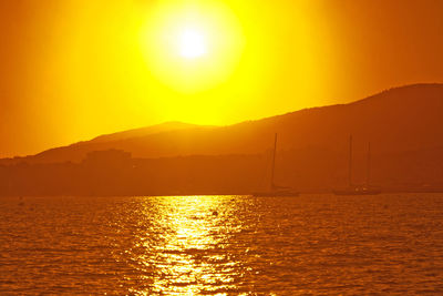 Scenic view of sea against orange sky