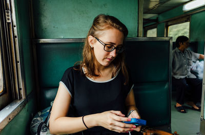 Portrait of a young woman using phone