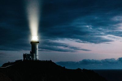 Low angle view of illuminated light against sky at night