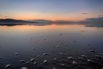 Scenic view of lake at sunset