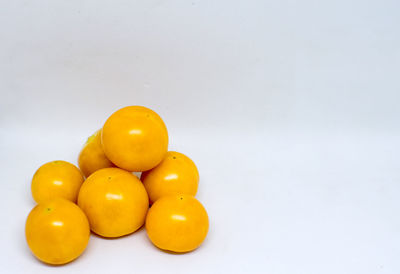 Close-up of orange over white background