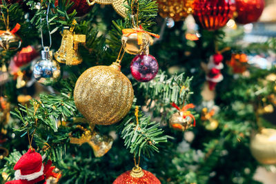 Close-up of christmas decorations hanging on tree