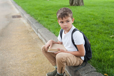 Boy sitting on book