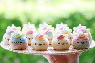 Close-up of hand holding cupcakes