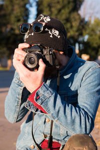 Trendy street photographer using 35mm camera