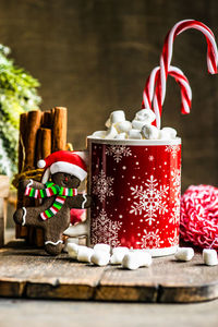 Christmas holiday flatlay with evergreen xmas tree and marshmallow on wooden background 