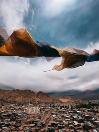 Aerial view of buildings and mountains against sky