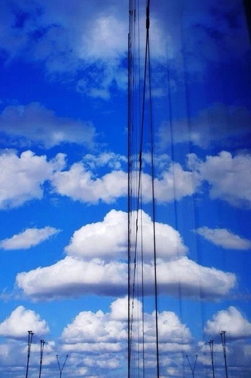 low angle view, sky, blue, cloud - sky, power line, electricity, electricity pylon, power supply, cloud, fuel and power generation, cable, technology, cloudy, connection, outdoors, nature, day, no people, pole, beauty in nature