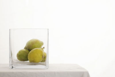 Close-up of apple on table against white background